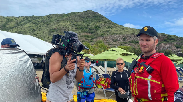 Kayak guide Santiago Stabile, ringed by a production team, talking to Seabourn Venture guests ahead of an excursion in St. Kitts. Photo Credit: Andrea Zelinski