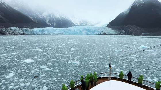 Atlas crusie lines in front of a glacier