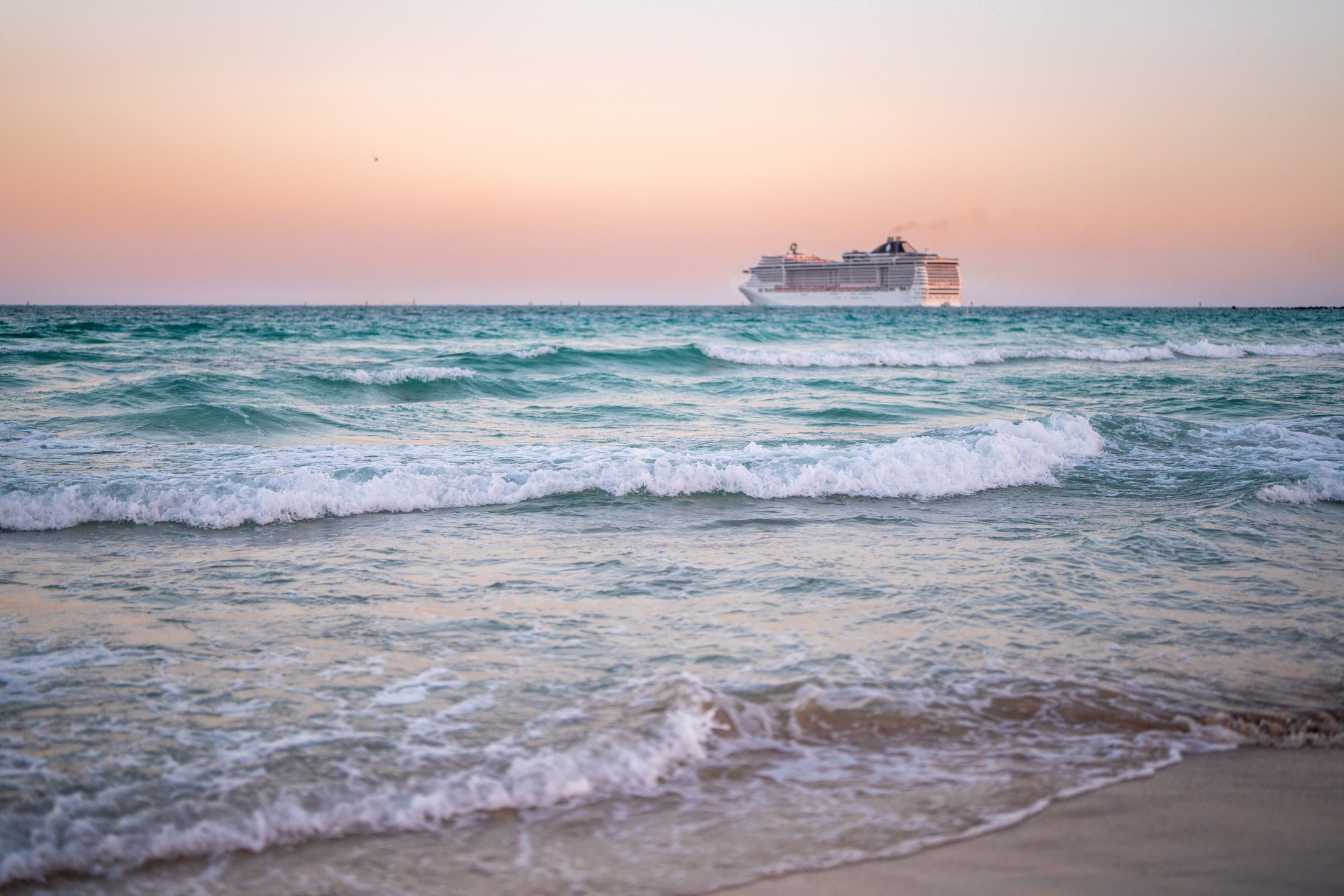 Cruise ship on the ocean. Luxury liner at sea. Miami Beach with cruise ship. Sea water and cruise liner. Tourist cruise ship near coast. Ocean waves and vessel boat. Summer dream vacation. Boat trip