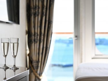 Two glasses of wine in the ship's cabin with balcony
