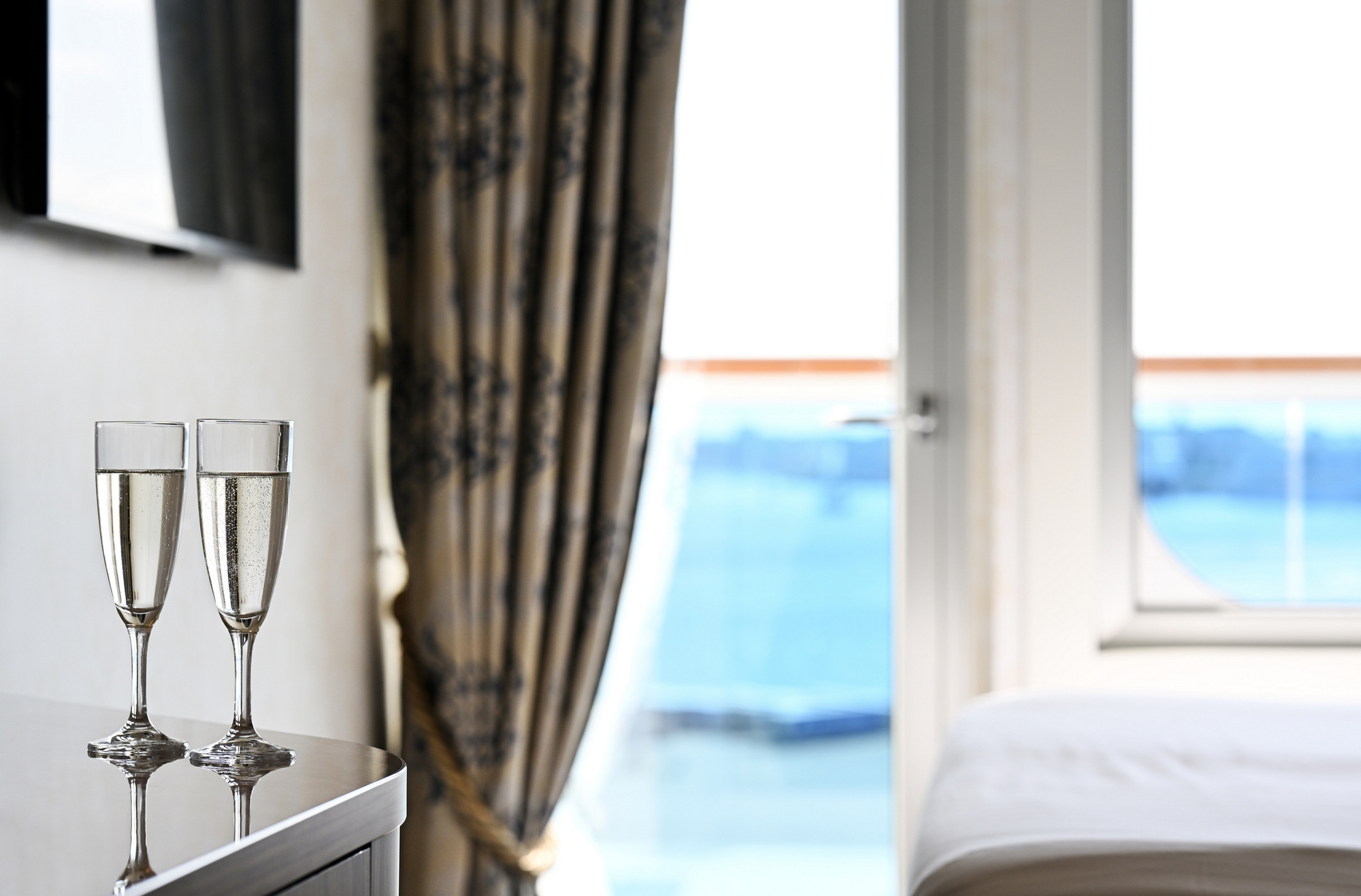 Two glasses of wine in the ship's cabin with balcony